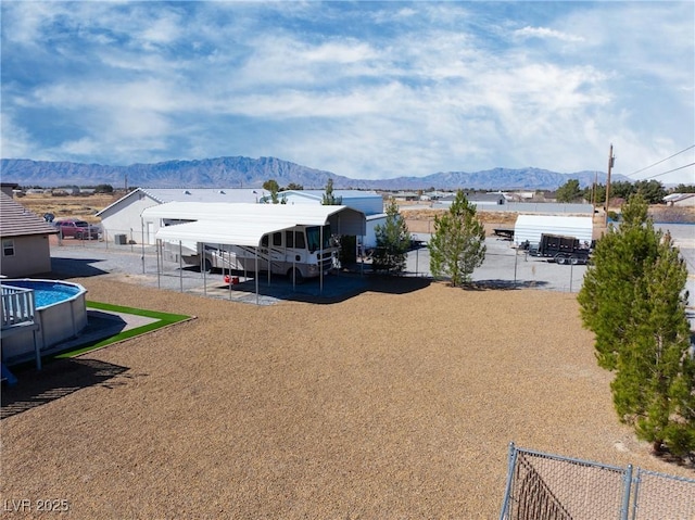 view of yard featuring a mountain view and fence