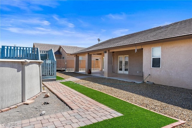 exterior space featuring a patio area, french doors, and fence