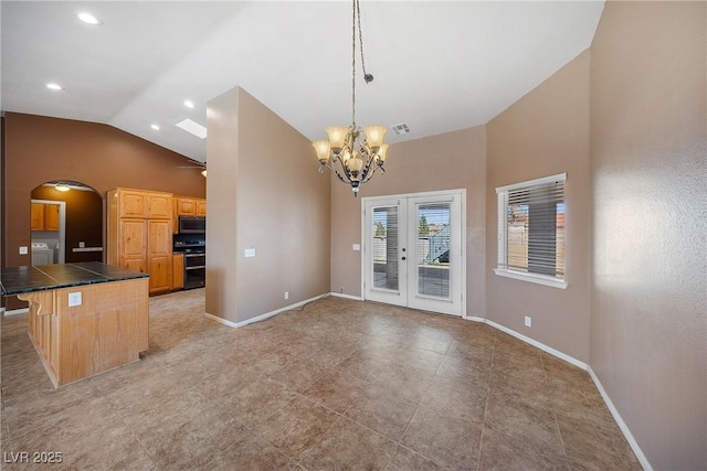 kitchen with arched walkways, visible vents, double oven range, and baseboards