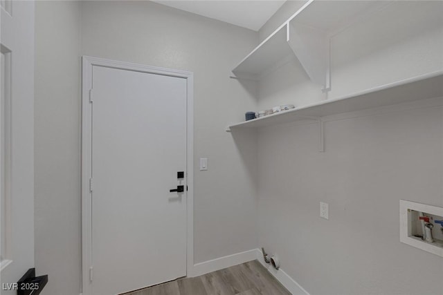 washroom featuring laundry area, wood finished floors, baseboards, and washer hookup