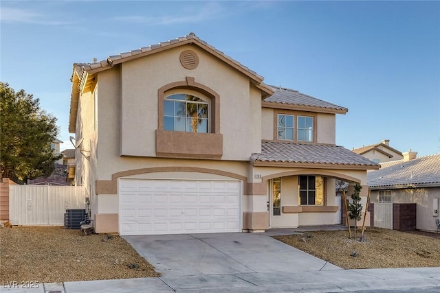 mediterranean / spanish-style home featuring a tile roof, stucco siding, driveway, and an attached garage