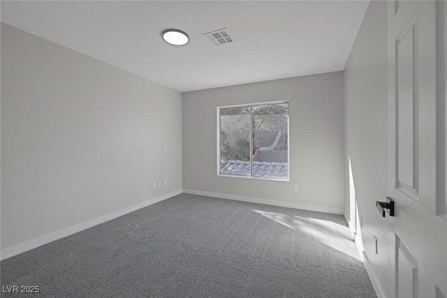 carpeted spare room featuring visible vents and baseboards