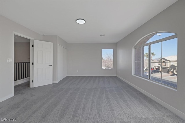 empty room with baseboards and carpet floors