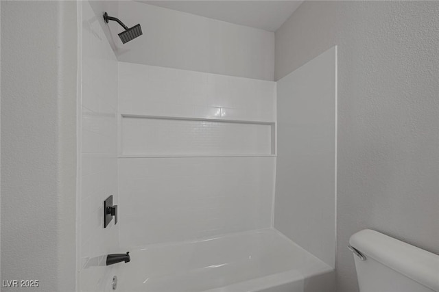 full bathroom featuring toilet, shower / bathtub combination, and a textured wall