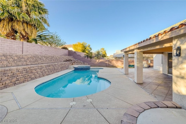 view of pool featuring a patio, a fenced backyard, and a pool with connected hot tub