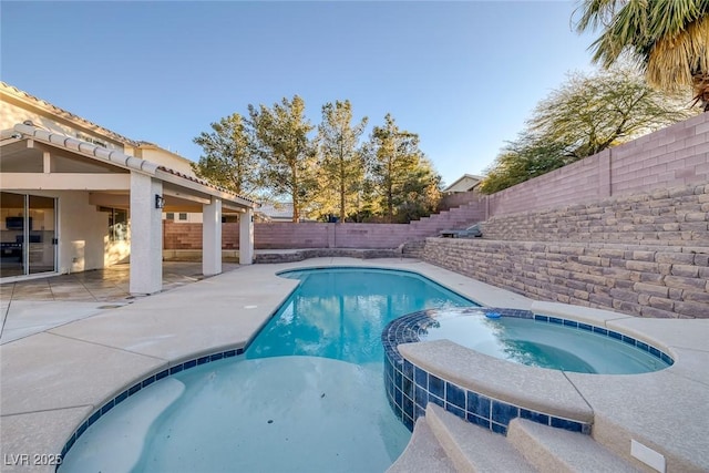 view of swimming pool with a patio area, a fenced backyard, and a pool with connected hot tub