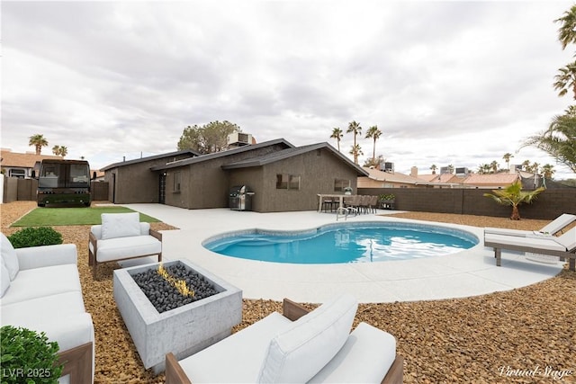 view of pool featuring a fenced backyard, grilling area, cooling unit, an outdoor living space with a fire pit, and a patio area