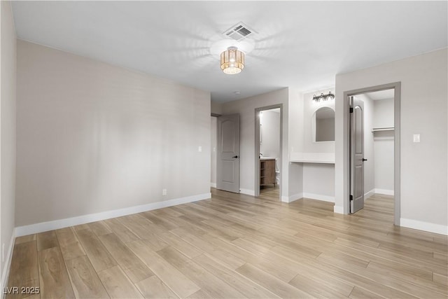 spare room with visible vents, baseboards, and light wood-style floors