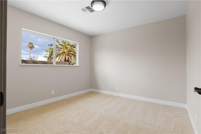 carpeted spare room featuring visible vents and baseboards