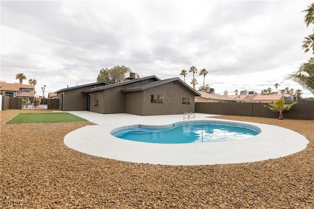 view of pool with central AC unit, a fenced backyard, a fenced in pool, and a patio area