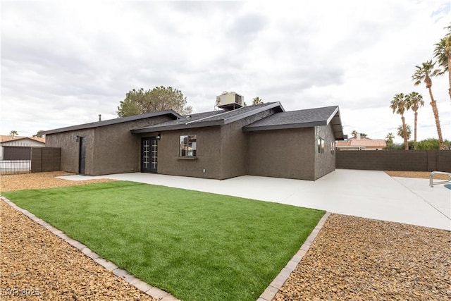 back of property with a patio area, central air condition unit, stucco siding, and fence