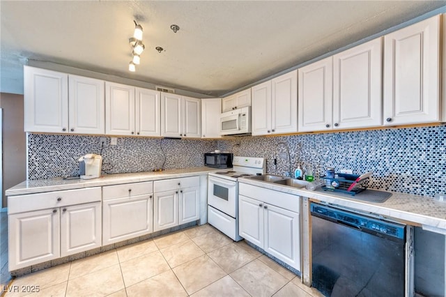 kitchen with white appliances, light tile patterned floors, decorative backsplash, light countertops, and white cabinets