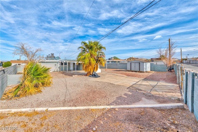 view of front of home with a shed, an outdoor structure, and a fenced backyard