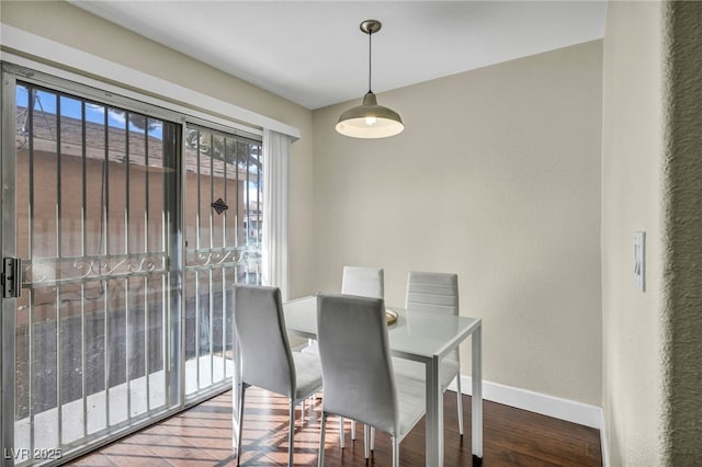 dining room with baseboards and wood finished floors