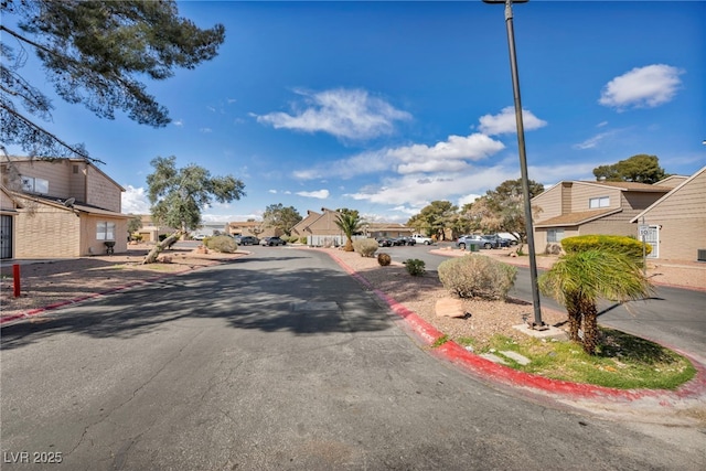 view of street with a residential view and curbs