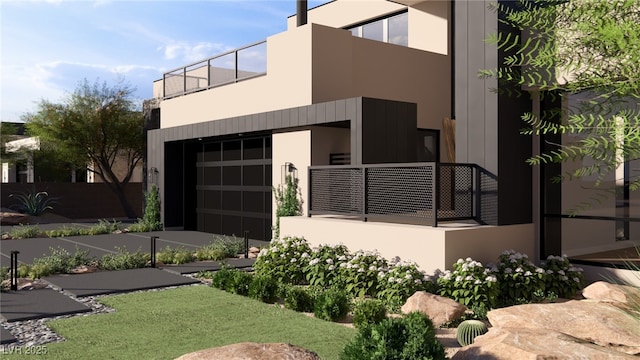 view of front facade with stucco siding and a balcony