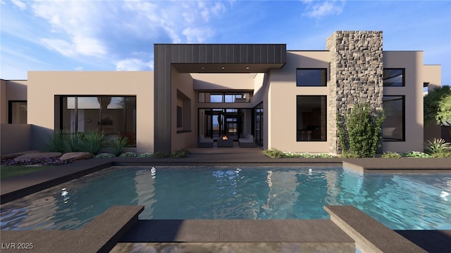 back of house with an outdoor pool and stucco siding