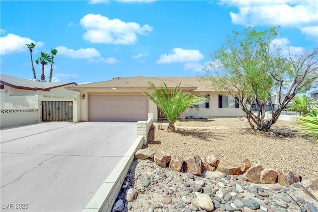 single story home with stucco siding, driveway, a garage, and fence