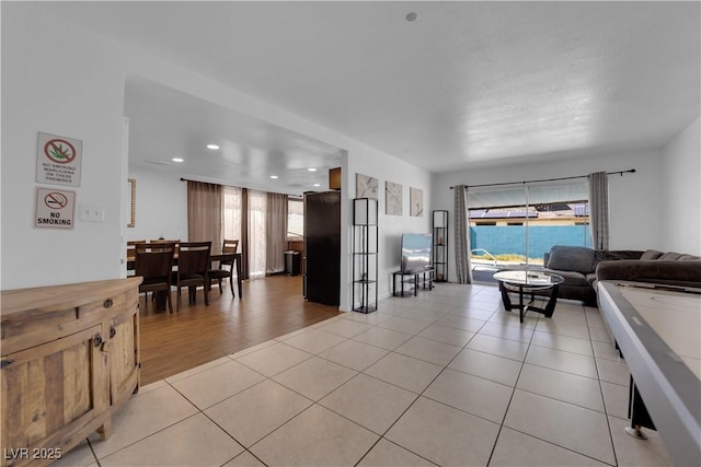 living room featuring light tile patterned floors, a healthy amount of sunlight, and recessed lighting