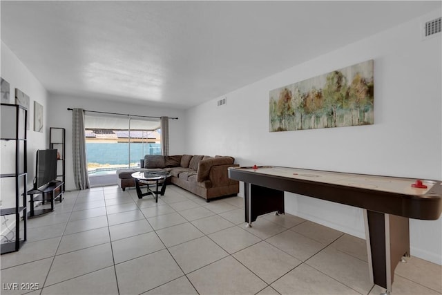 living area with visible vents and light tile patterned flooring