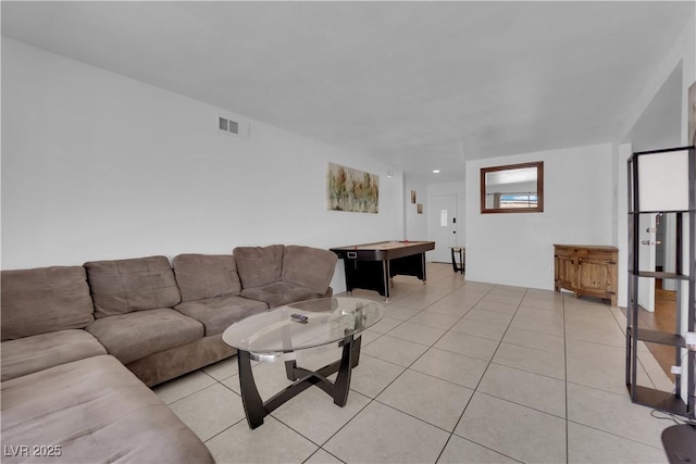 living area with light tile patterned floors and visible vents