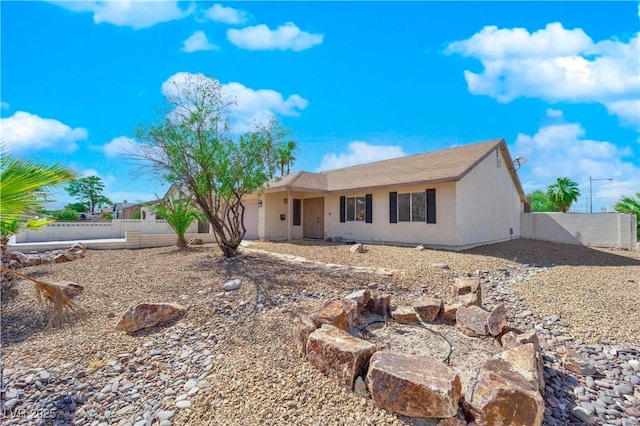 ranch-style home with fence, a garage, and stucco siding