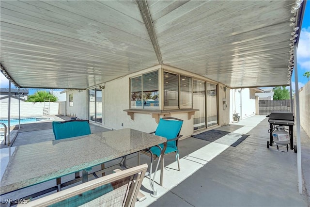 view of patio / terrace featuring outdoor dining area, a fenced backyard, and a fenced in pool