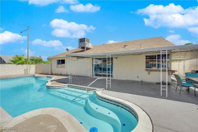 view of pool with a patio, cooling unit, a fenced in pool, and fence