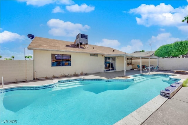 view of swimming pool with a fenced in pool, fence, central AC, and a patio area