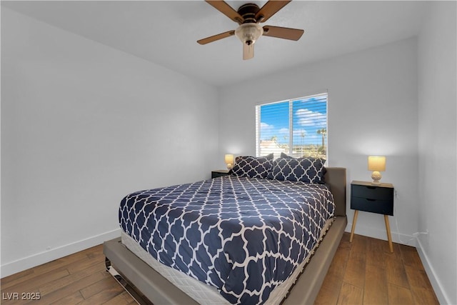 bedroom featuring baseboards, hardwood / wood-style floors, and a ceiling fan