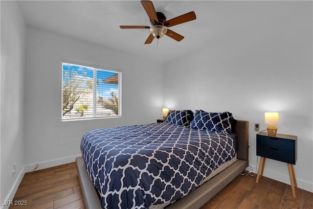 bedroom with baseboards, wood-type flooring, and ceiling fan