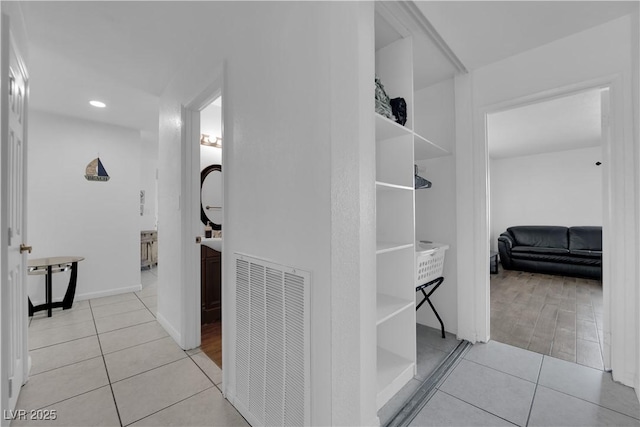 hall with light tile patterned floors and visible vents