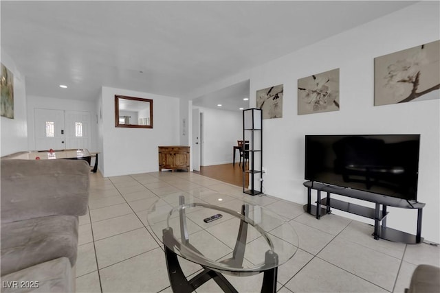 living area featuring light tile patterned flooring and recessed lighting