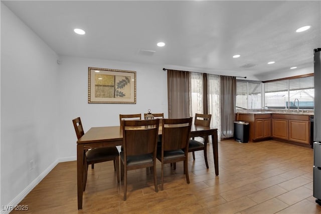 dining room featuring recessed lighting and light wood-style flooring