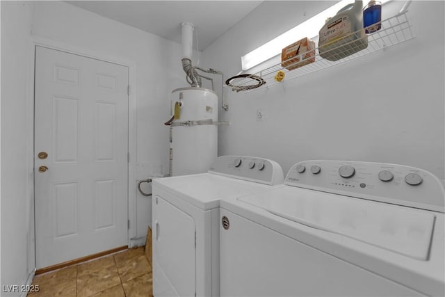 laundry area featuring light tile patterned floors, laundry area, secured water heater, and washing machine and dryer