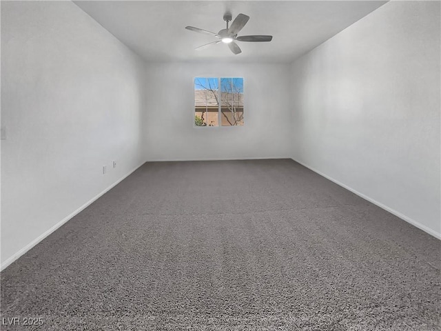 carpeted spare room featuring a ceiling fan and baseboards