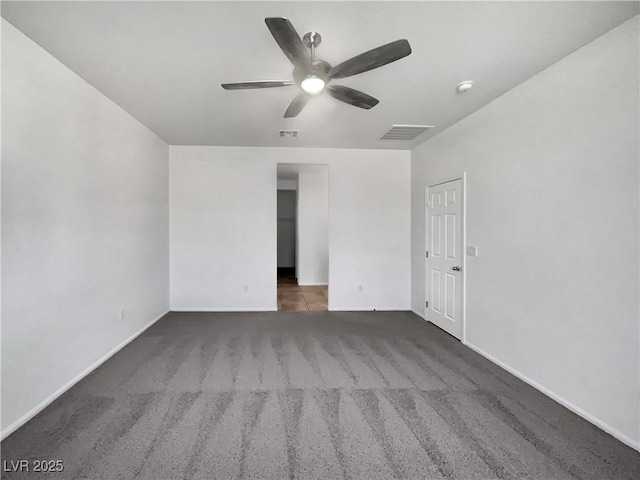 unfurnished bedroom with carpet flooring, baseboards, visible vents, and ceiling fan