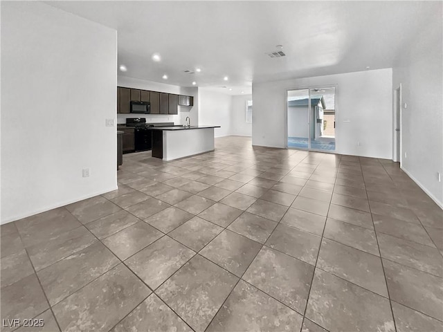 unfurnished living room with tile patterned flooring, visible vents, and recessed lighting