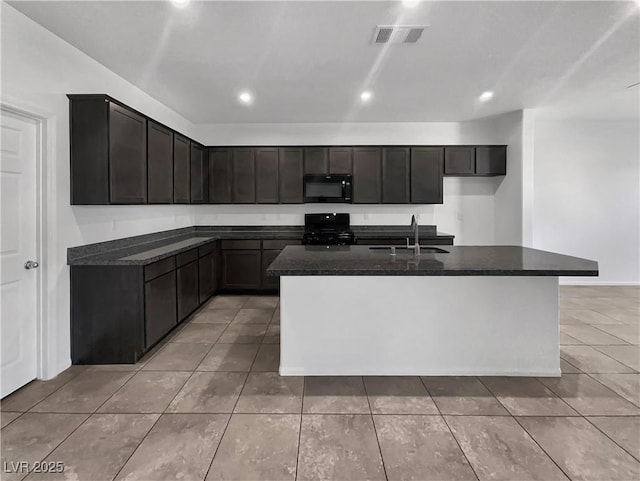 kitchen with visible vents, black appliances, a kitchen island with sink, a sink, and light tile patterned floors