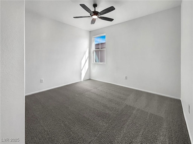 empty room featuring baseboards, dark colored carpet, and ceiling fan