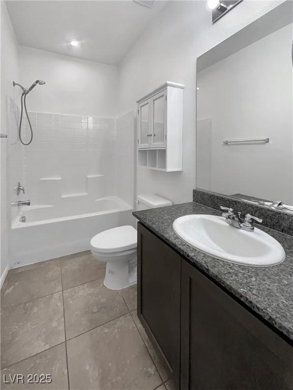 full bathroom featuring washtub / shower combination, toilet, vanity, and tile patterned flooring