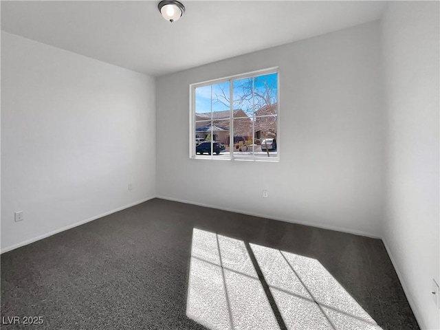 spare room featuring baseboards