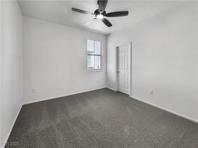 spare room with ceiling fan, baseboards, and dark colored carpet