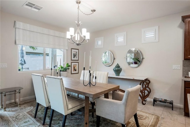 dining area featuring light tile patterned floors, baseboards, visible vents, and a chandelier