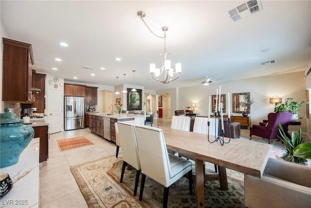 dining room with recessed lighting, visible vents, arched walkways, and light tile patterned flooring