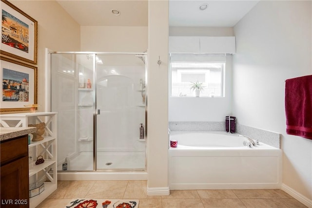 full bathroom featuring a shower stall, baseboards, a garden tub, tile patterned floors, and vanity