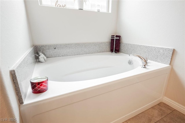 bathroom with tile patterned flooring and a garden tub