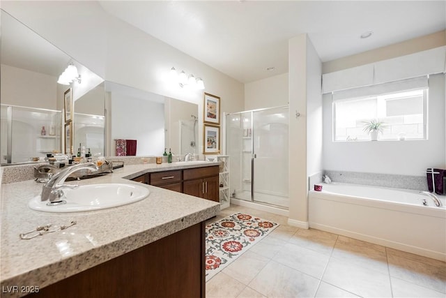 bathroom with tile patterned floors, a stall shower, a bath, and vanity