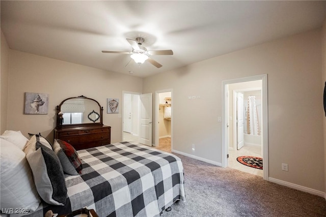 bedroom with ensuite bath, carpet, baseboards, and ceiling fan