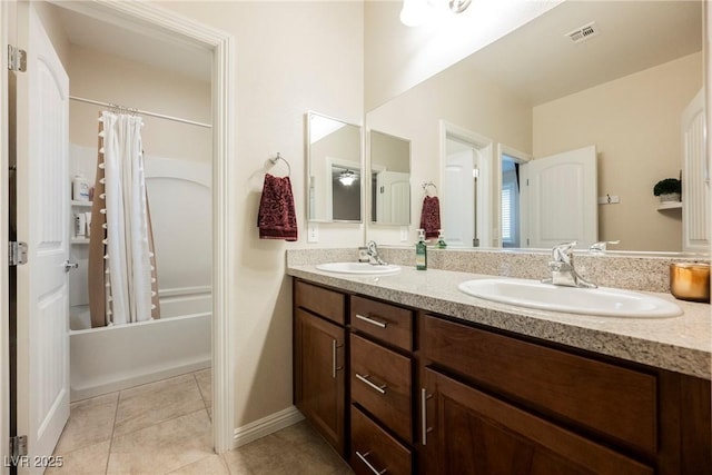 bathroom featuring double vanity, visible vents, tile patterned flooring, and a sink